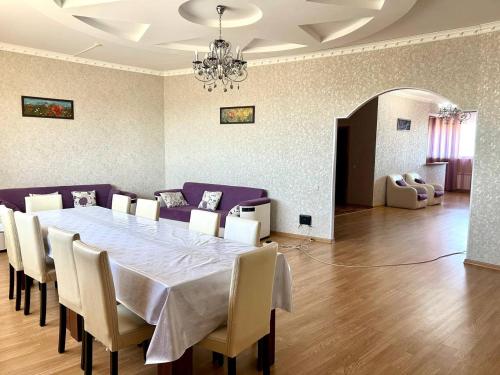 a dining room with a table and chairs at Просторная 3 комнатная квартира in Atyrau