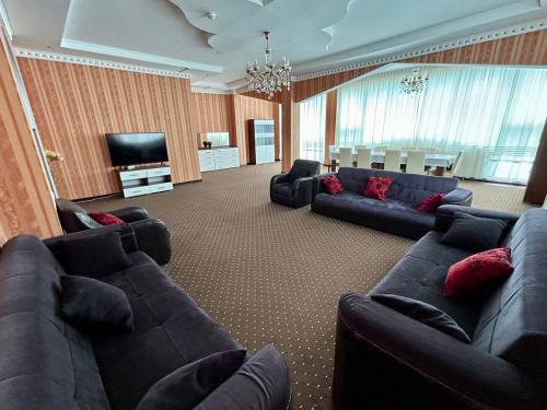 a large living room with couches and a television at Просторная 3 комнатная квартира in Atyrau