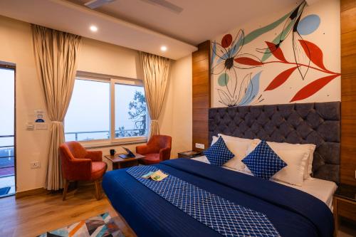 a hotel room with a bed and a large window at Shalom Backpackers Mussoorie in Mussoorie