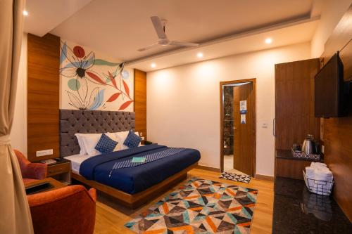 a bedroom with a bed and a tv in it at Shalom Backpackers Mussoorie in Mussoorie