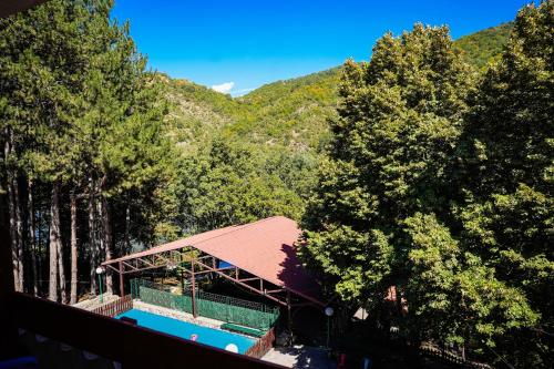 an overhead view of a building with a pool in the forest at Hotel Gradche in Kochani