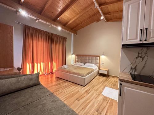 a bedroom with a bed and a large window at Arial Penthouse Suites in Vlorë