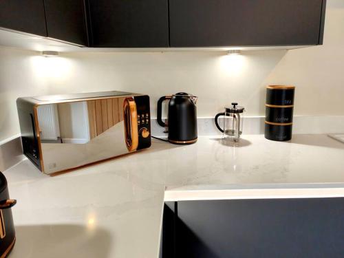 a kitchen counter with a toaster and a microwave on it at Carvetii - ANNE House Room 1 - Dbl bed Ground floor en-suite in Carlisle