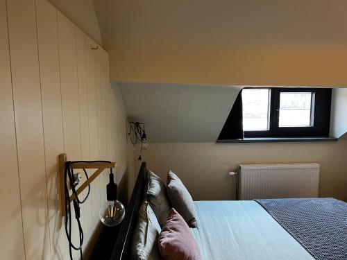 a bedroom with a bed and a window at Goodnight Leuven - Self check-in with airco in Leuven
