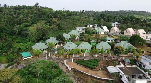 an aerial view of a village with houses and trees at Moss Adams Inn in Vagamon