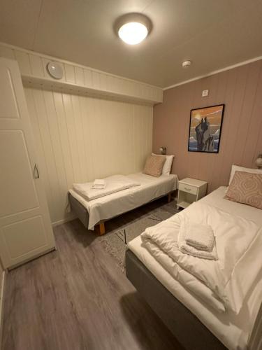a bedroom with two beds in a room at Lofoten Rorbuer in Svolvær