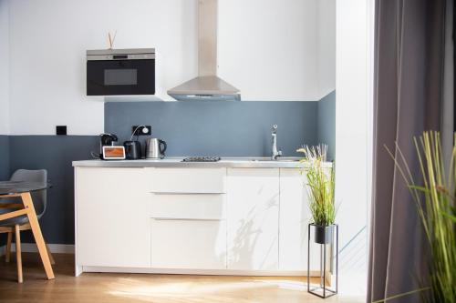 a kitchen with white cabinets and a sink at Sweet San Francisco in Alicante