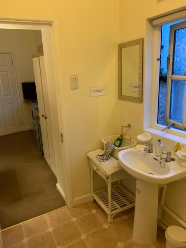 a bathroom with a sink and a window at Broadwalk in Coltishall