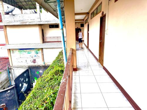 a person walking down a hallway of a building at Vang Vieng Global Hostel in Vang Vieng