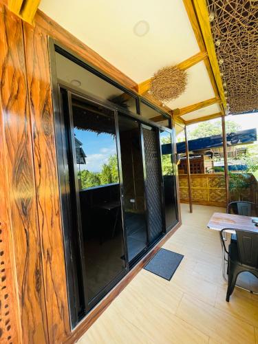 a room with glass doors and a table and chairs at Vafi Hills Bed And Breakfast in San Isidro