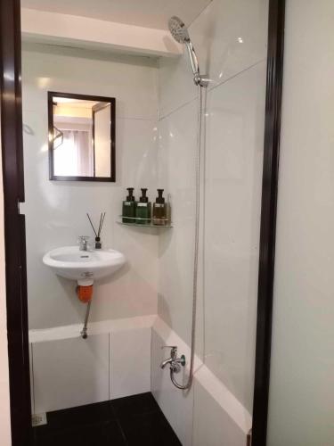 a bathroom with a sink and a shower at Z and j Transient Pad in Butuan