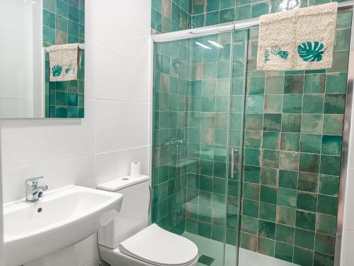 a bathroom with a toilet and a sink and a shower at Daydream Medano Coliving in El Médano