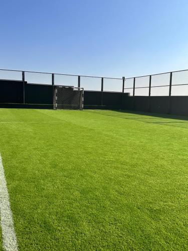 a soccer field with a goal and green grass at Kinda vip in Al Mashāriqah