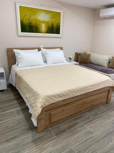 a bedroom with a large bed in a room at Persephone in Himare
