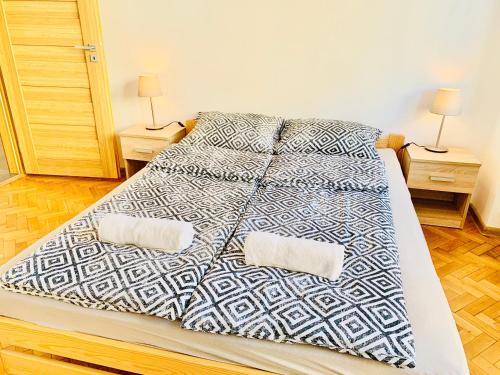 a bed with two pillows on it in a bedroom at Apartament SŁONECZNY in Bydgoszcz