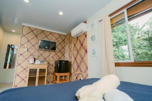 a bedroom with a teddy bear sitting on a bed at Vafi Hills Bed And Breakfast in San Isidro