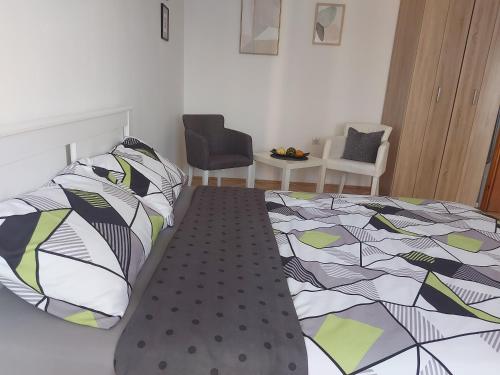 a bedroom with a bed with a colorful comforter at Nikola NS2 in Novi Sad