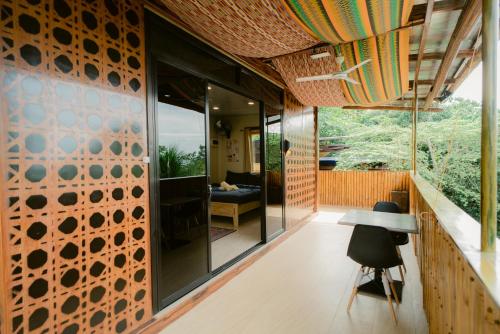 an external view of a house with glass doors and a table at Vafi Hills Bed And Breakfast in San Isidro