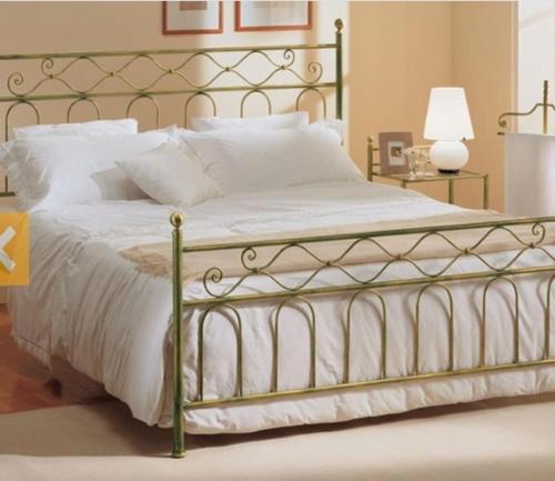 a bedroom with a large bed with white pillows at La casa delle fate in Giave