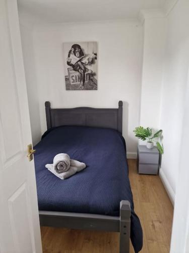 a bed with a towel on it in a bedroom at Home in Melton Mowbray in Melton Mowbray