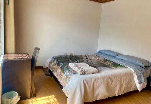 a bedroom with a bed in a room at Casa Bianca in Bogotá