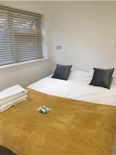two beds in a room with two pillows at THE NEST in Nottingham