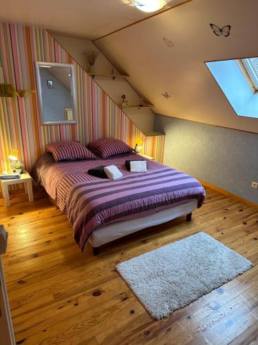 a bedroom with a large bed in a attic at La maison des copains in Damery
