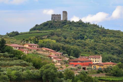 a town on a hill with a castle on top at Sporting Hotel San Felice in Illasi