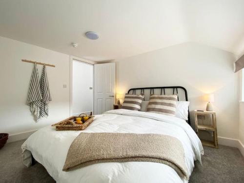 a bedroom with a bed with a basket of fruit on it at Apartment One at The Courtyard, Number 11 in Crewe