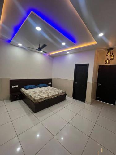a bedroom with a bed and a blue ceiling at Luxury 3bhk villa (mere bebe da villa)@gopal nagar in Jalandhar