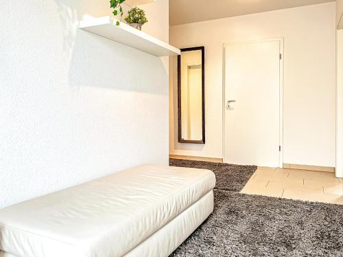 a room with a white bed and a white door at Tarnewitz Pierre Wohnung Pierre 01 in Tarnewitz