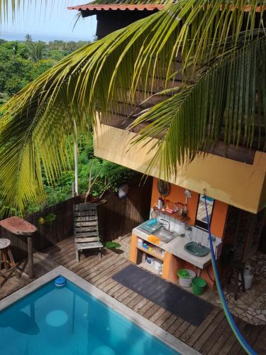 a backyard with a kitchen and a swimming pool at Casa Gio Paraiso Escondido in Puerto Escondido
