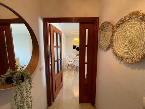 a hallway with an open door and a mirror at BOHO HOUSE MALAGA in Málaga
