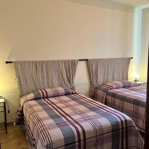 a hotel room with two beds in a room at B&B Podere Cottimellino - Montalcino - Val d'Orcia in Montalcino