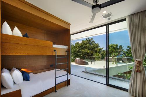 Ein Bett oder Betten in einem Zimmer der Unterkunft Villa Serangan - Private Beach Access
