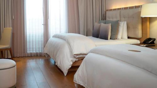 a hotel room with two beds and a lamp at Cartesiano Boutique & Wellness Hotel in Puebla