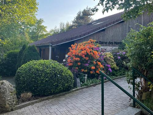 a building with flowers and a sign on it at Notre Dame des Monts in Ban-sur-Meurthe-Clefcy