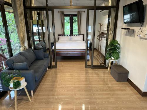 a living room with a couch and a bed at Good View House - Koh Yao Noi in Ko Yao Noi