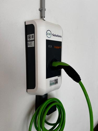 a green hose is hooked up to a soap dispenser at Maurig Appartements in Elbigenalp