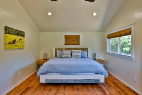 a bedroom with a bed and a window at A Cozy Cabin In The Country in Hawi
