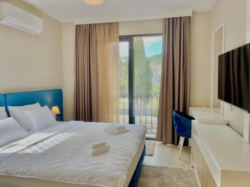 a bedroom with a bed and a large window at Comfort Apartments Pasha in Budva
