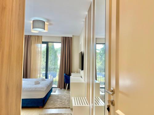 a hotel room with a bed and a window at Comfort Apartments Pasha in Budva