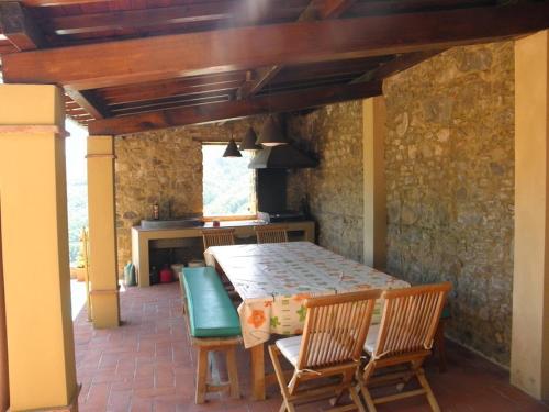 a dining room with a table and chairs and a kitchen at Palazzo D'arcato by PosarelliVillas in Lugliano