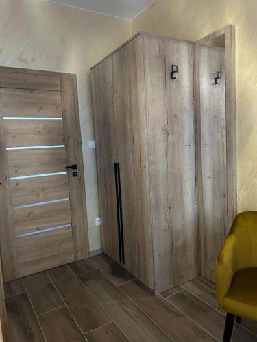 a room with wooden cabinets and a closet at Villa Potôň 2023 in Horná Potôň