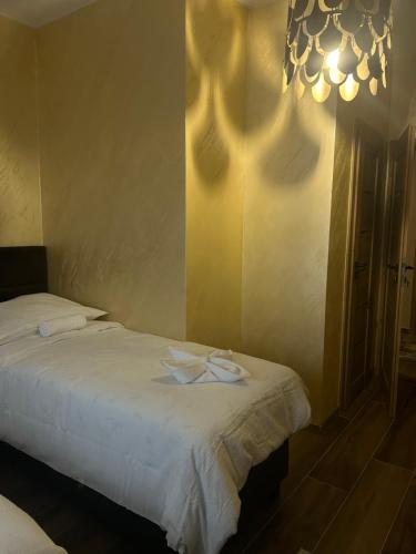 a bedroom with two beds and a chandelier at Villa Potôň 2023 in Horná Potôň