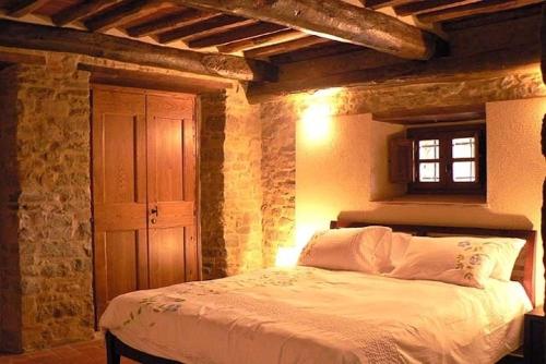 a bedroom with a bed and a window in it at Palazzo D'arcato by PosarelliVillas in Lugliano