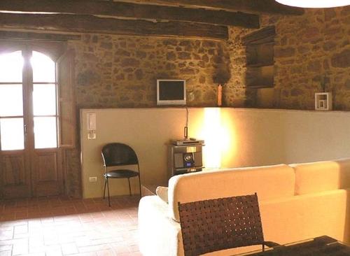 a living room with a couch and a chair at Palazzo D'arcato by PosarelliVillas in Lugliano