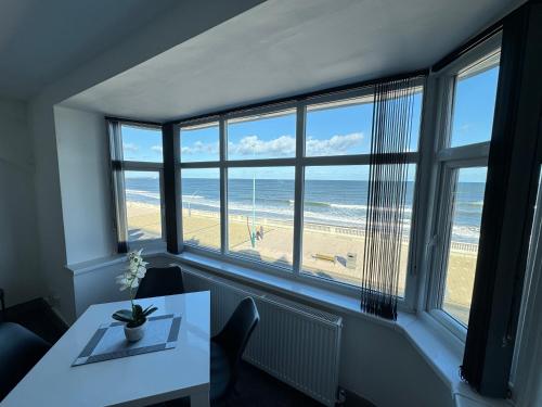a dining room with a table and a view of the beach at Seaviews Apartment 1, Whitley Bay Sea Front in Whitley Bay