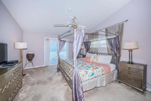 a bedroom with a canopy bed and a window at Florida Villa in Palm Harbor