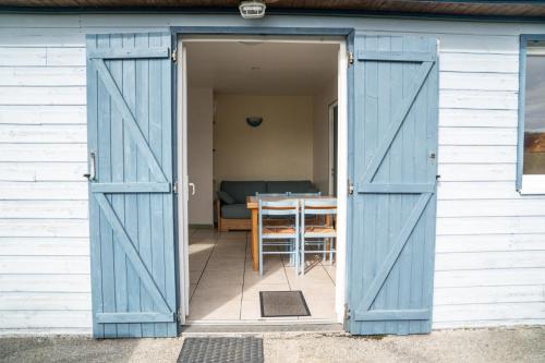 an open barn door with a table in a room at Gites 4,6 personnes Fécamp Etretat in Colleville